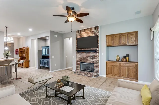 a living room with fireplace furniture and a flat screen tv