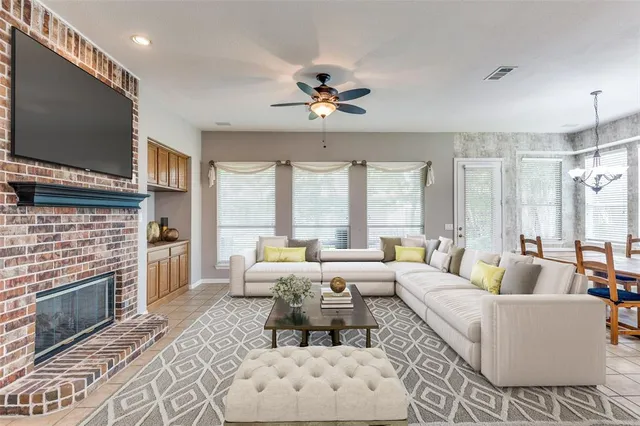 a living room with furniture fireplace and flat screen tv