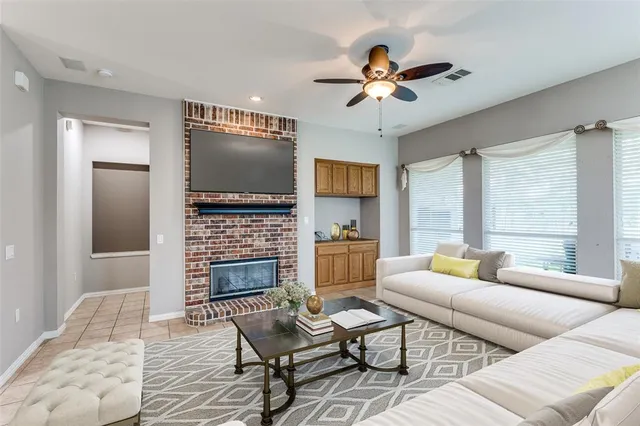 a living room with fireplace furniture and a floor to ceiling window