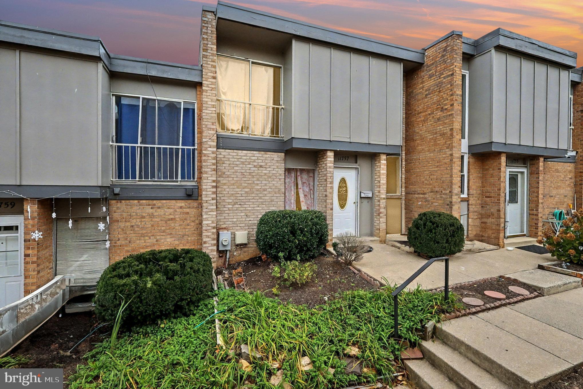 a view of a house with potted plants