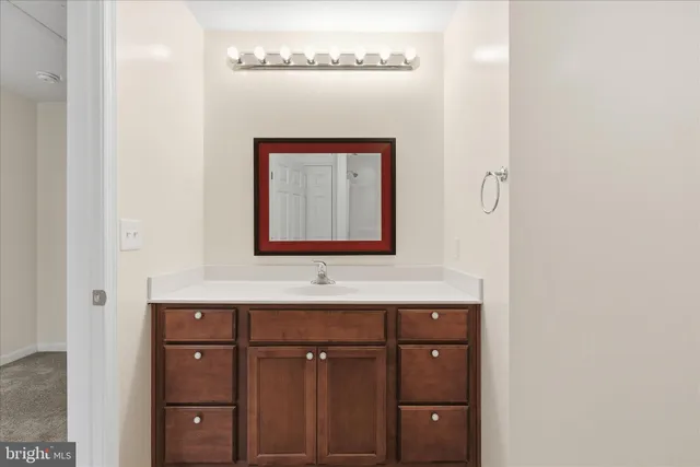 a bathroom with a sink vanity and mirror