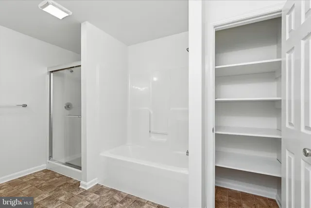 a bathroom with a bathtub and a shower