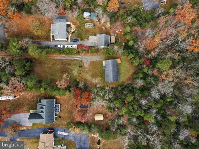 an aerial view of a house with a yard and lake view
