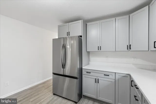 a kitchen with cabinets and stainless steel appliances