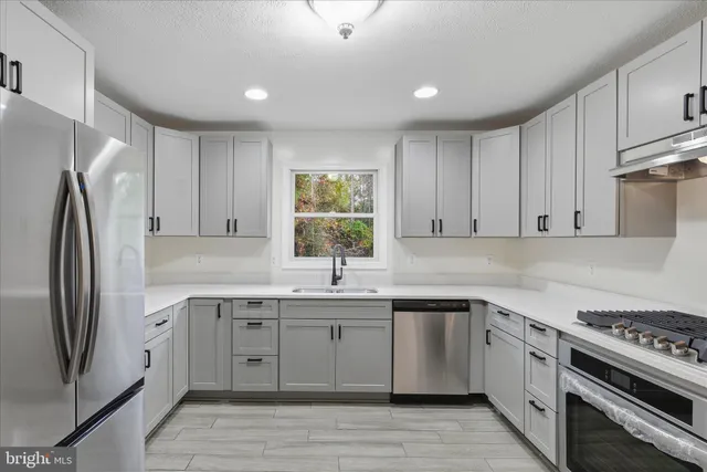a kitchen with a sink stove and refrigerator