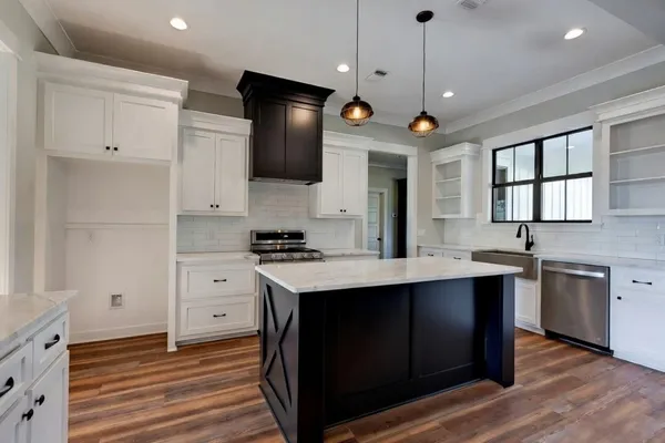 a kitchen with stainless steel appliances a stove sink and microwave