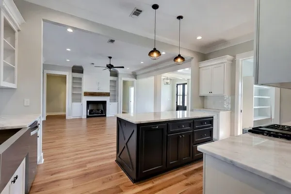 a kitchen with kitchen island a sink stainless steel appliances and cabinets