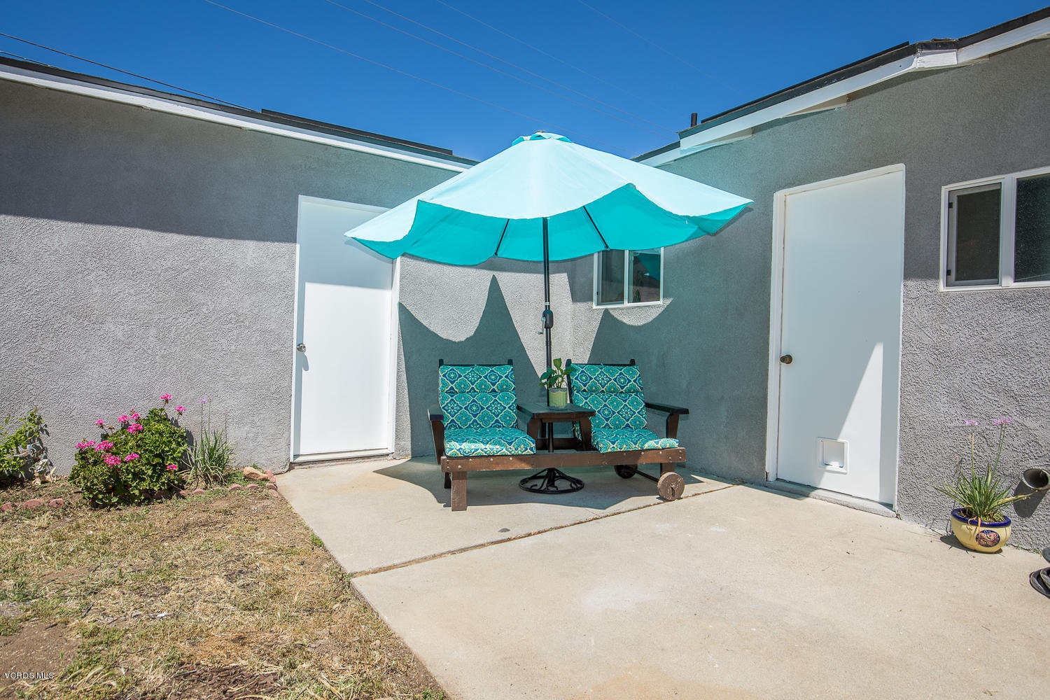 250 Brook Road Newbury Park, CA 91320 - Photo 14 of 18 a view of a backyard with a table and chairs under an umbrella