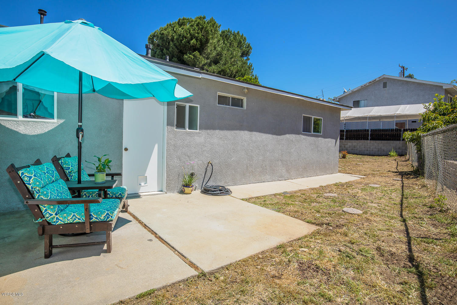 250 Brook Road Newbury Park, CA 91320 - Photo 17 of 18 a patio with a table and chairs under an umbrella