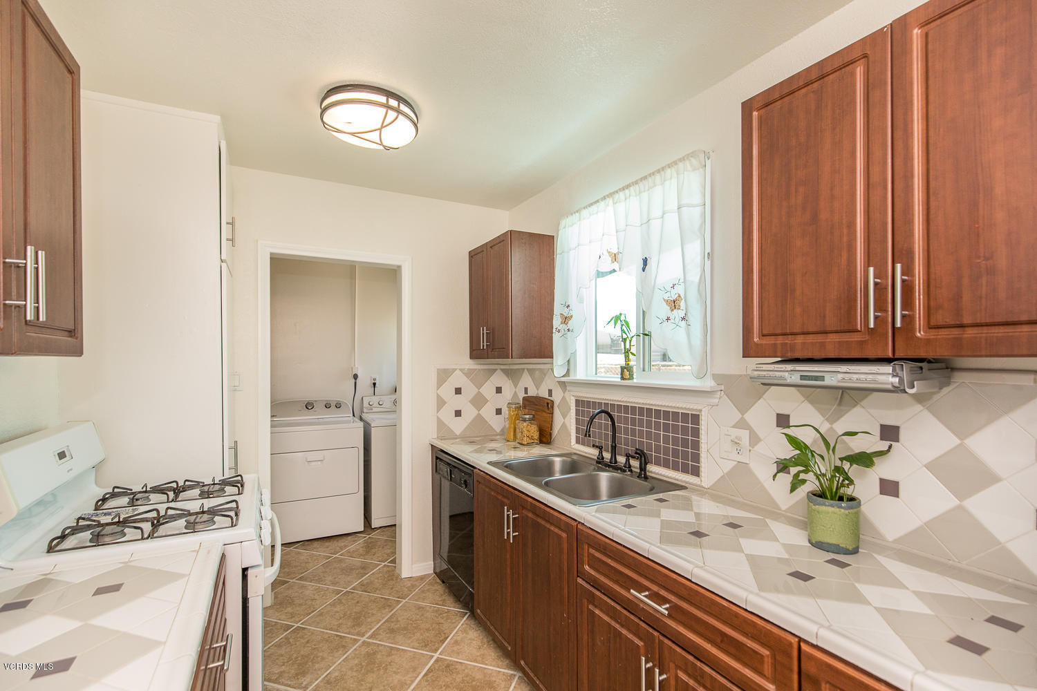 250 Brook Road Newbury Park, CA 91320 - Photo 6 of 18 a kitchen with stainless steel appliances a sink stove and cabinets