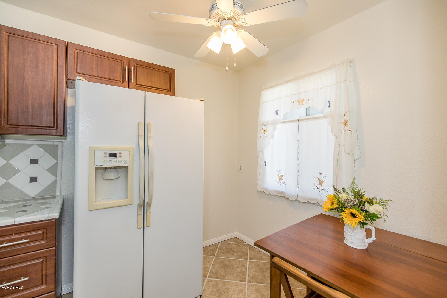 250 Brook Road Newbury Park, CA 91320 - Photo 7 of 18 a white kitchen with a refrigerator and a table