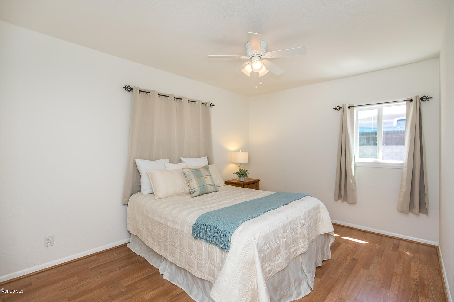 250 Brook Road Newbury Park, CA 91320 - Photo 9 of 18 a bedroom with a large bed and wooden floor