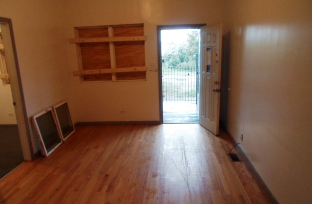 2236 West 47th Place Chicago, IL 60609 - Photo 2 of 18 an empty room with wooden floor and windows