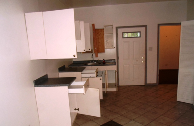 2236 West 47th Place Chicago, IL 60609 - Photo 4 of 18 a kitchen with a sink and a stove top oven