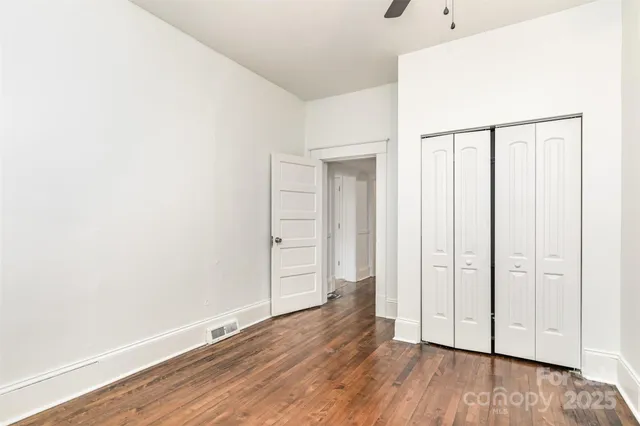 a view of hallway with wooden floor