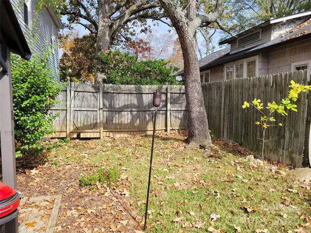 a backyard of a house with a tree