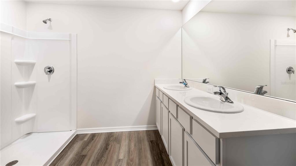 10931 Rabbit Grove Trail Palmetto, FL 34221 - Photo 12 of 30 a bathroom with a sink and a mirror