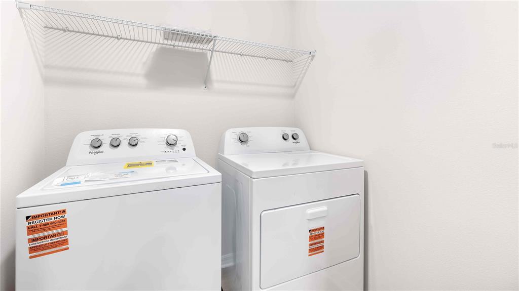 10931 Rabbit Grove Trail Palmetto, FL 34221 - Photo 16 of 30 a utility room with dryer and washer