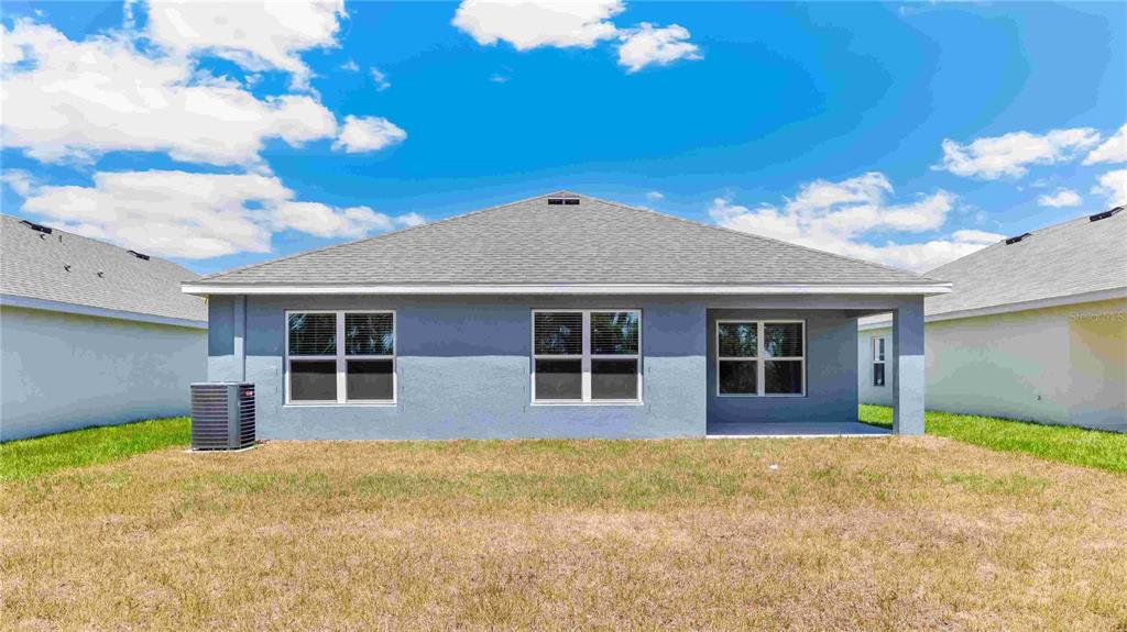 10931 Rabbit Grove Trail Palmetto, FL 34221 - Photo 18 of 30 a house view with a backyard space