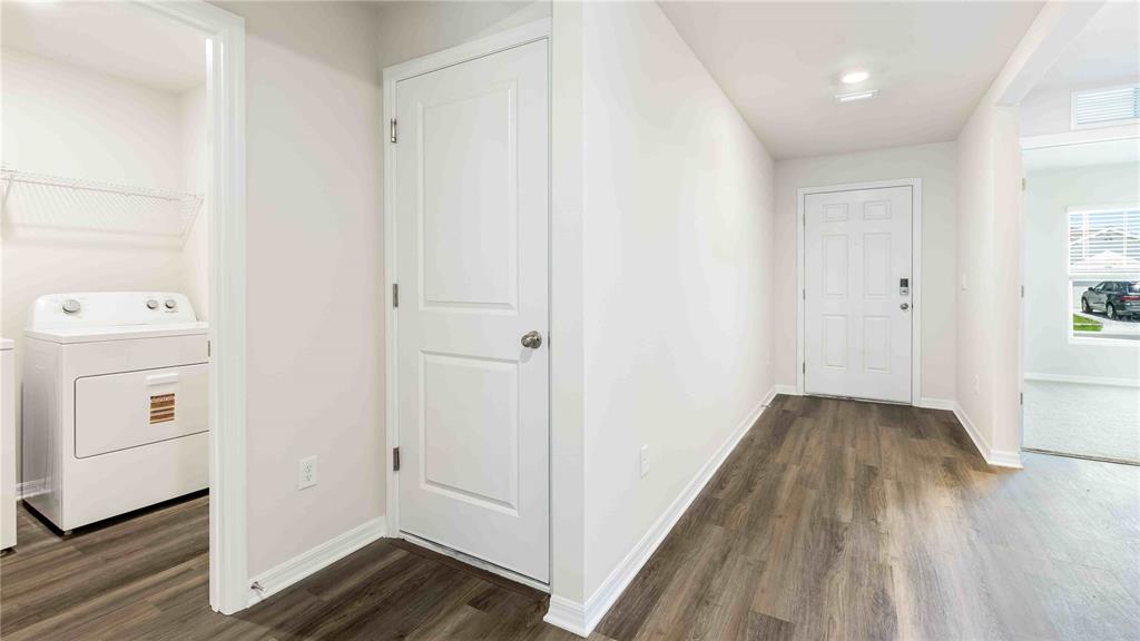 10931 Rabbit Grove Trail Palmetto, FL 34221 - Photo 2 of 30 a view of a hallway with wooden floor and closet area