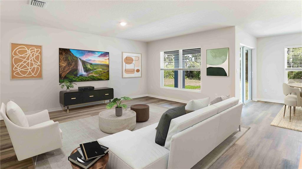 10931 Rabbit Grove Trail Palmetto, FL 34221 - Photo 8 of 30 a living room with furniture and floor to ceiling windows