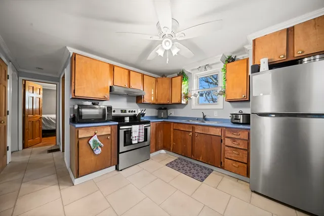 a kitchen with stainless steel appliances granite countertop a stove and a refrigerator