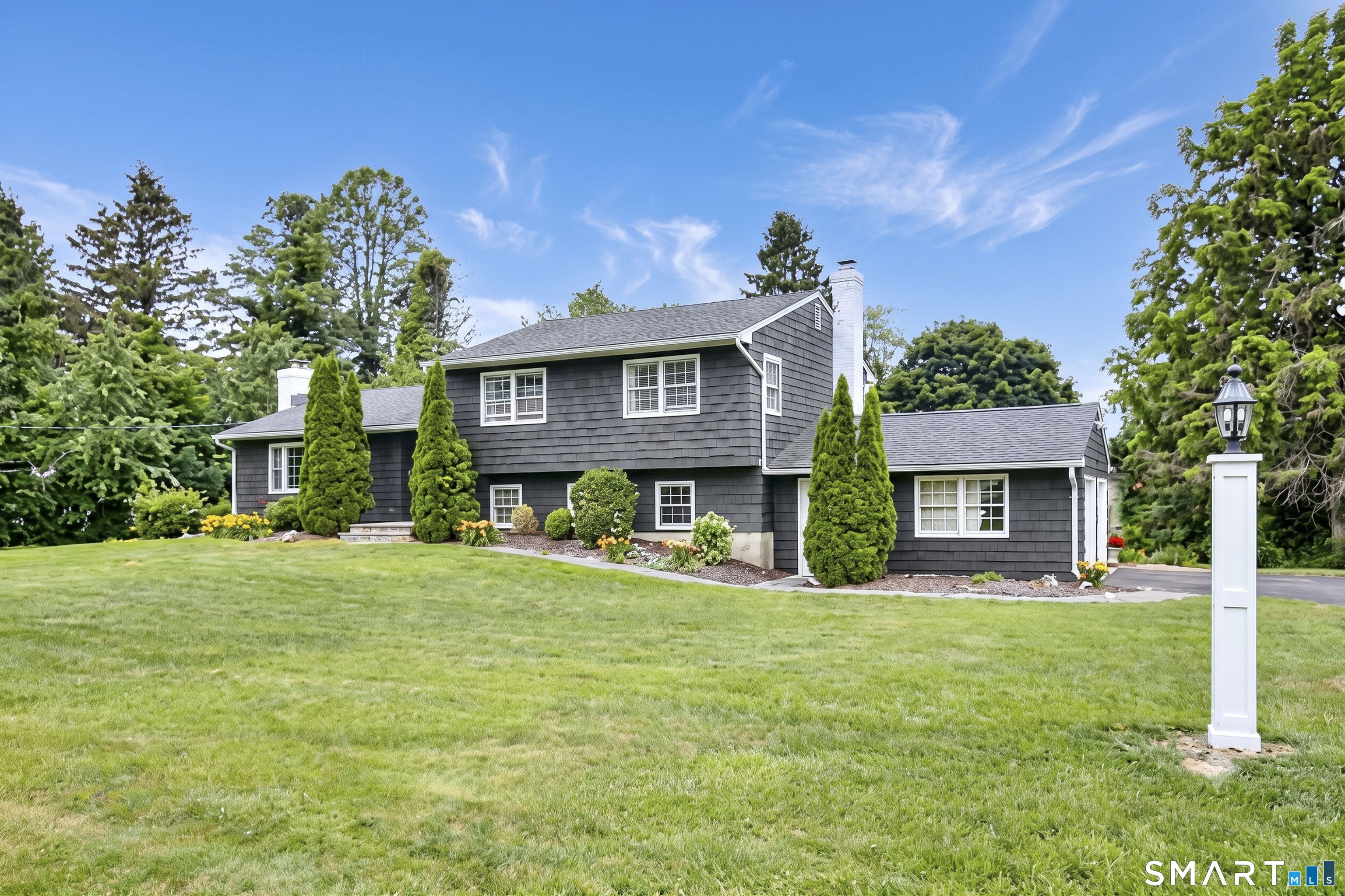 324 Ridge Road Orange, CT 06477 - Photo 1 of 38 a front view of a house with a yard