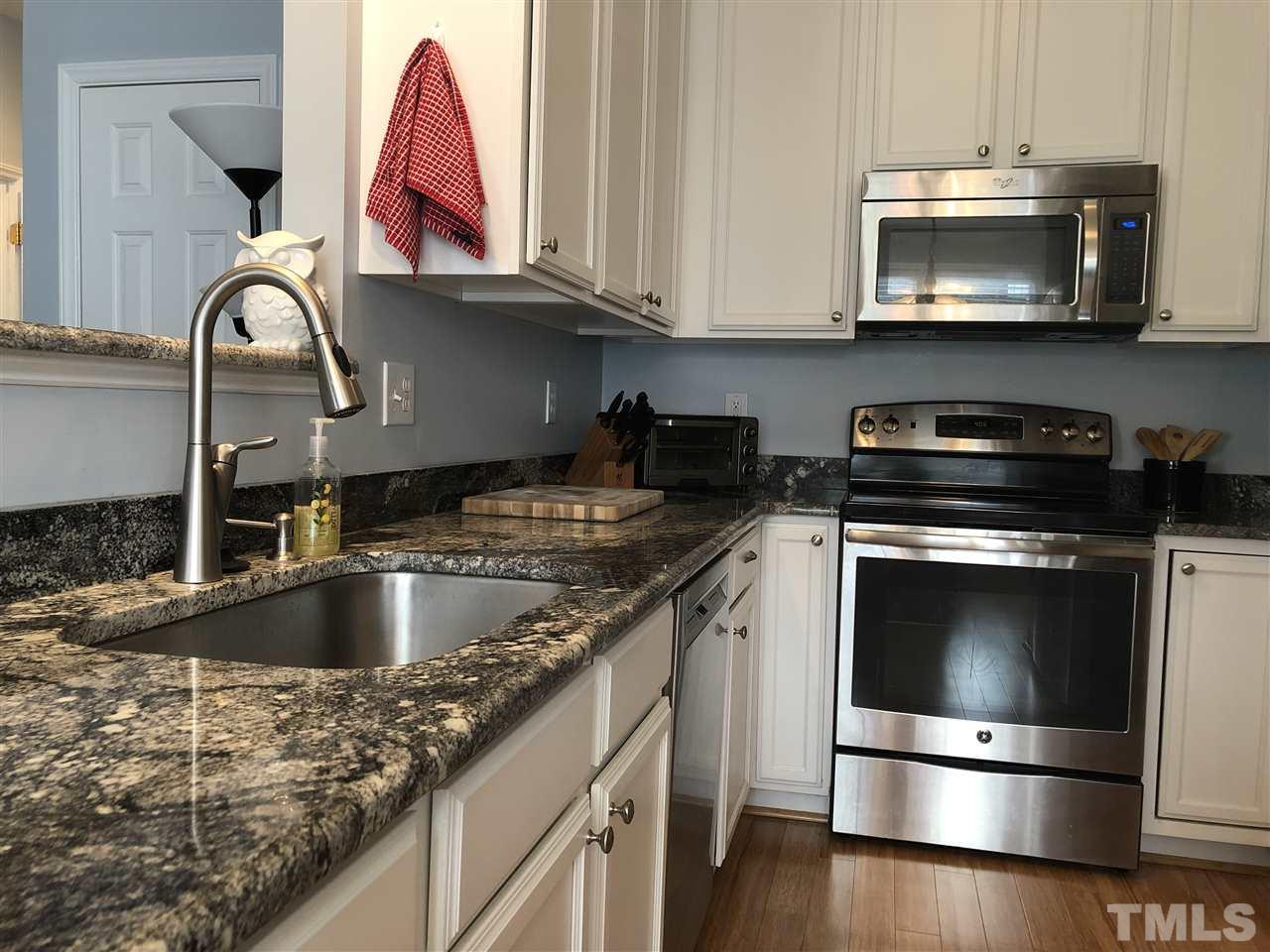 5426 Goldenglow Way Raleigh, NC 27606 - Photo 2 of 25 a kitchen with granite countertop a stove and a sink