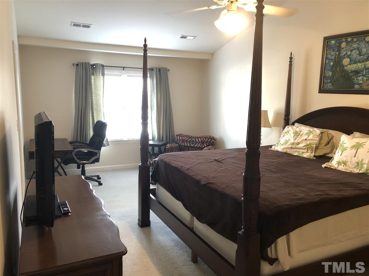 5426 Goldenglow Way Raleigh, NC 27606 - Photo 13 of 25 a large bed sitting in a bedroom next to a window