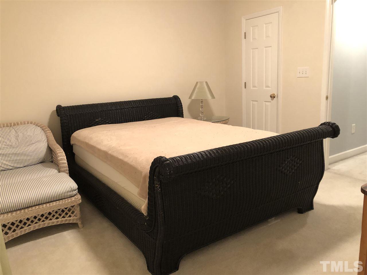 5426 Goldenglow Way Raleigh, NC 27606 - Photo 17 of 25 a bedroom with a bed and a night stand