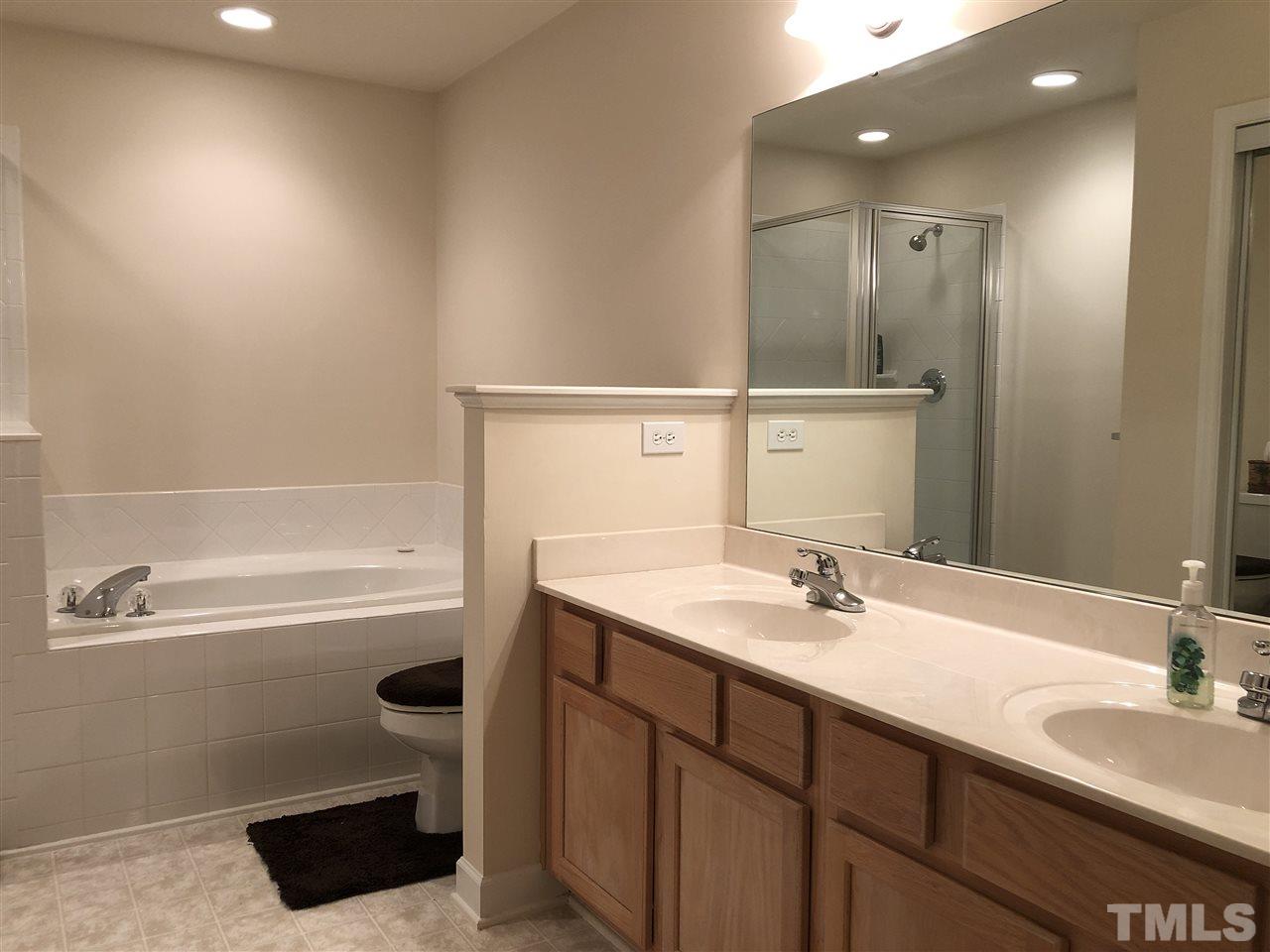 5426 Goldenglow Way Raleigh, NC 27606 - Photo 19 of 25 a bathroom with a sink a toilet and shower