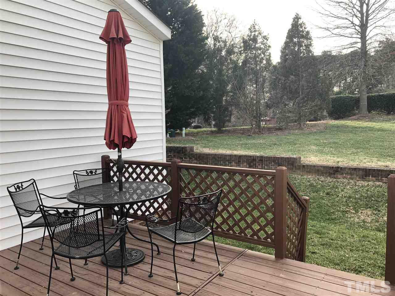 5426 Goldenglow Way Raleigh, NC 27606 - Photo 24 of 25 a view of a chairs and table on the wooden deck