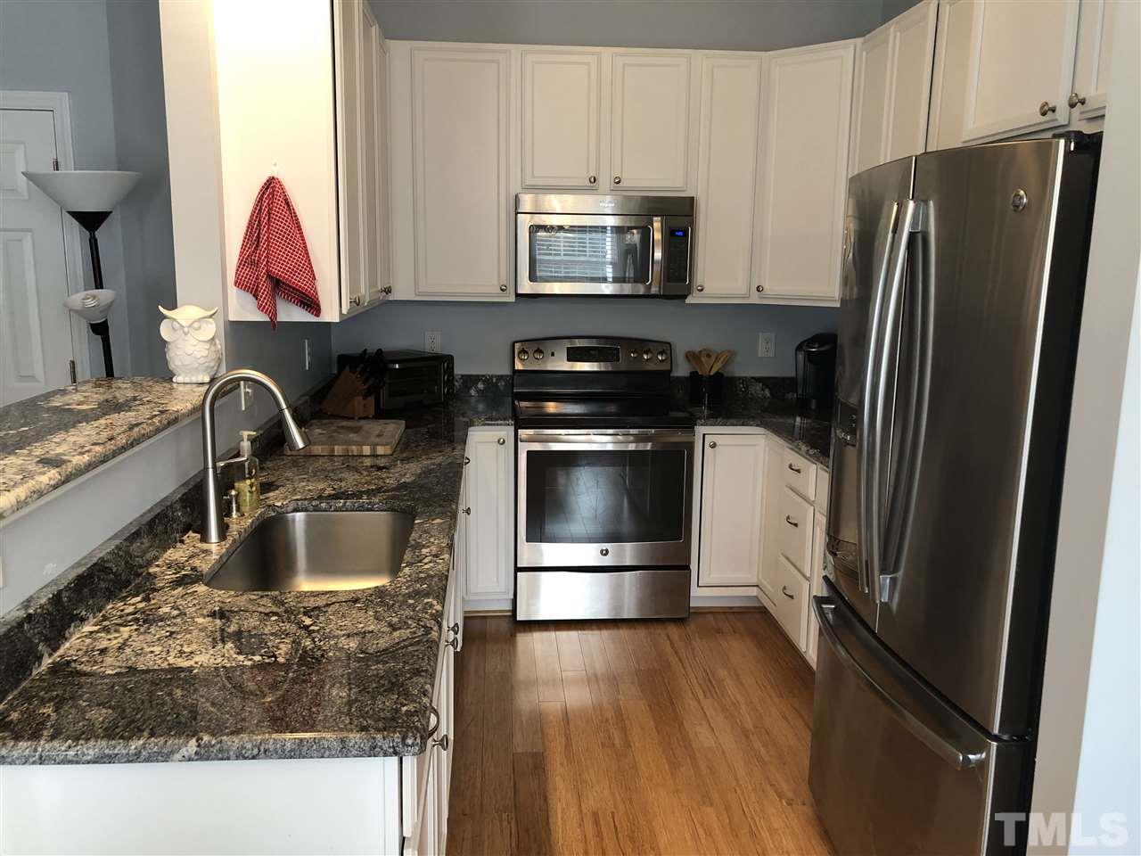 5426 Goldenglow Way Raleigh, NC 27606 - Photo 4 of 25 a kitchen with a sink stove and refrigerator