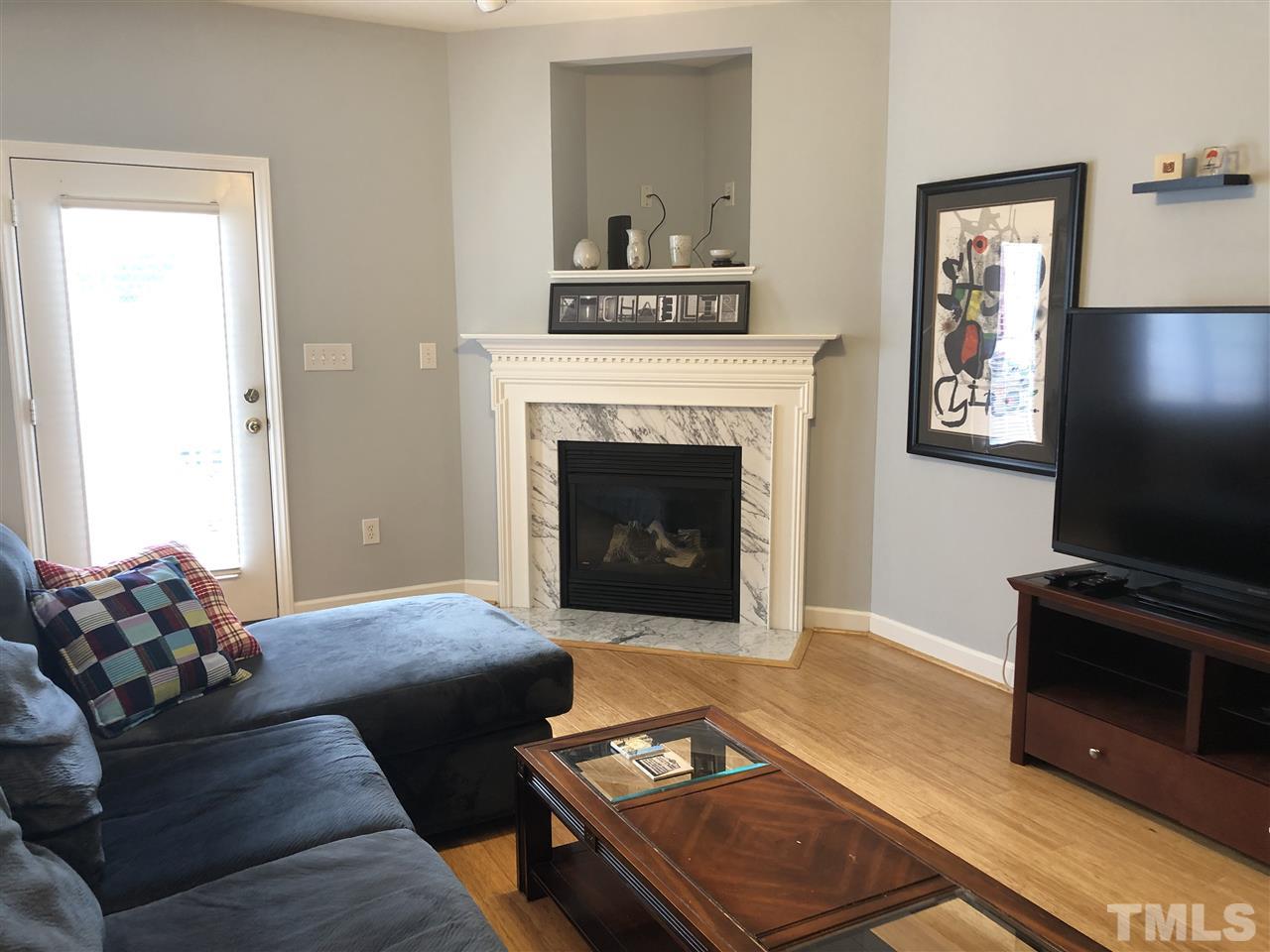 5426 Goldenglow Way Raleigh, NC 27606 - Photo 5 of 25 a living room with furniture and a fireplace