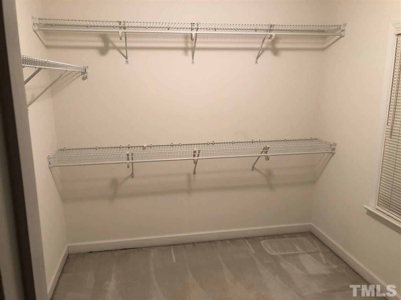 5426 Goldenglow Way Raleigh, NC 27606 - Photo 6 of 25 a view of a room with racks on the wall