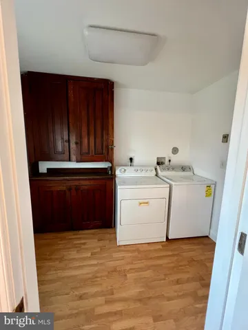 a view of kitchen with refrigerator sink and cabinets