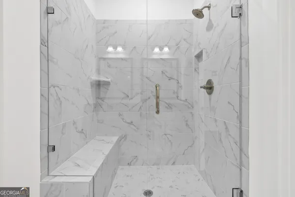 a bathroom with a granite countertop sink mirror and shower