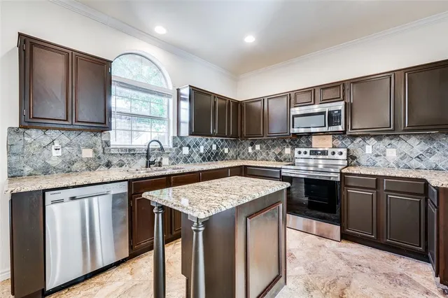 a kitchen with a sink stove and cabinets