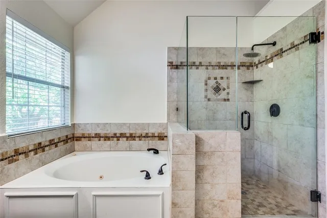 a bathroom with a bathtub and shower