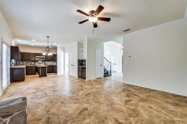 a view of kitchen with refrigerator stove and microwave