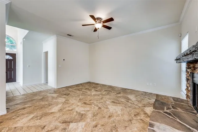 a view of a livingroom with a ceiling fan and window