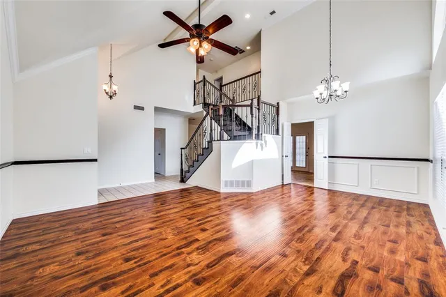a view of a livingroom with wooden floor and a ceiling fan