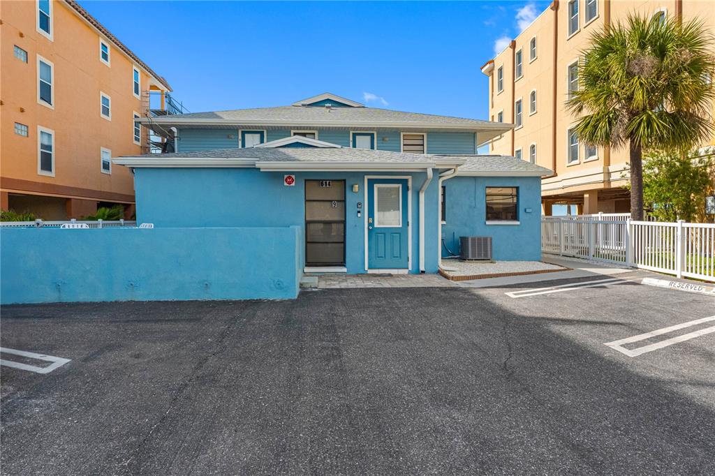 614 Gulf Boulevard, Unit 9 Indian Rocks Beach, FL 33785 - Photo 1 of 41 a front view of a house with a yard