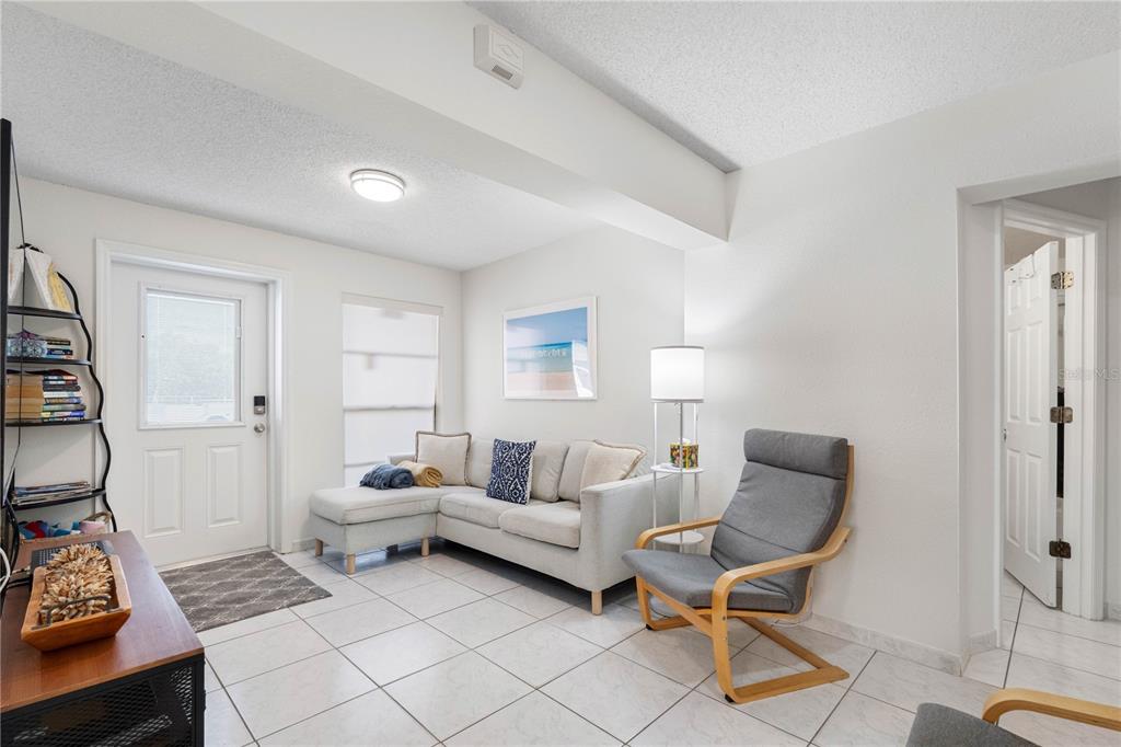 614 Gulf Boulevard, Unit 9 Indian Rocks Beach, FL 33785 - Photo 12 of 41 a living room with furniture a rug and a window