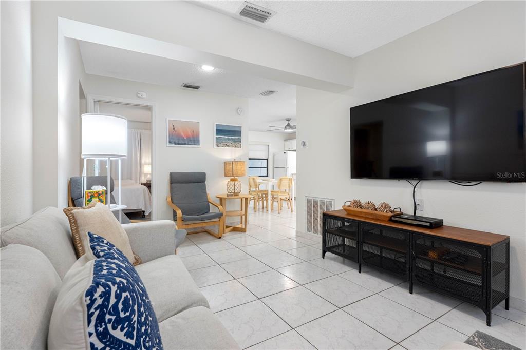 614 Gulf Boulevard, Unit 9 Indian Rocks Beach, FL 33785 - Photo 14 of 41 a living room with furniture and a flat screen tv