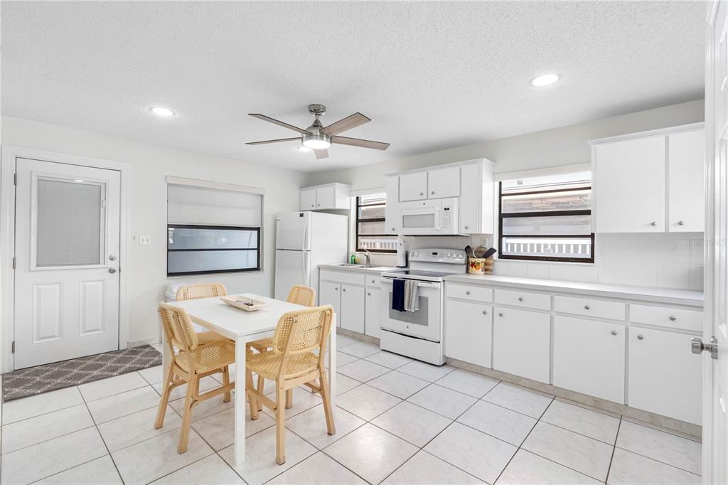 614 Gulf Boulevard, Unit 9 Indian Rocks Beach, FL 33785 - Photo 20 of 41 a kitchen with cabinets and chairs