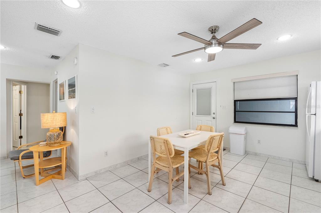 614 Gulf Boulevard, Unit 9 Indian Rocks Beach, FL 33785 - Photo 23 of 41 a view of a dining room with furniture and wooden floor
