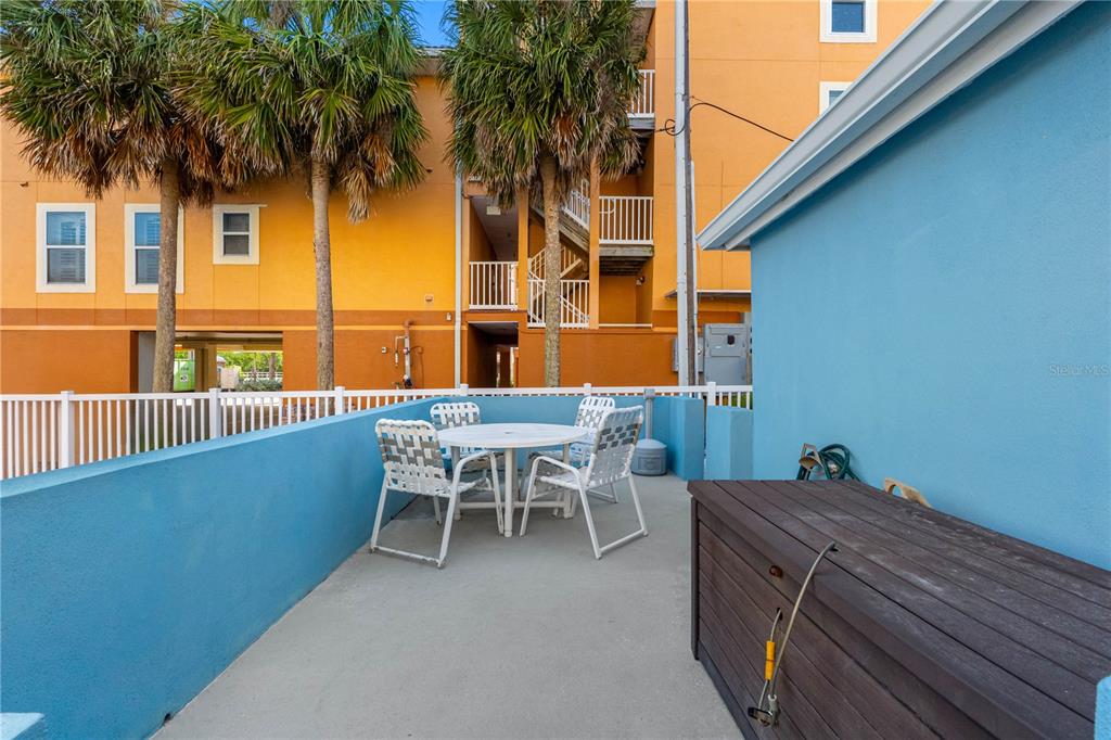 614 Gulf Boulevard, Unit 9 Indian Rocks Beach, FL 33785 - Photo 24 of 41 a view of a terrace with a table and chairs