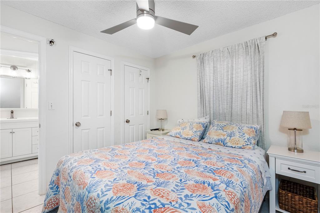 614 Gulf Boulevard, Unit 9 Indian Rocks Beach, FL 33785 - Photo 26 of 41 a bedroom with a bed and a chandelier