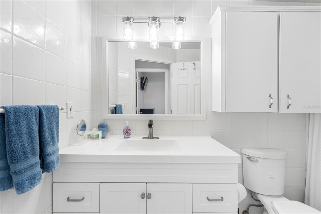 614 Gulf Boulevard, Unit 9 Indian Rocks Beach, FL 33785 - Photo 28 of 41 a bathroom with a sink and a mirror